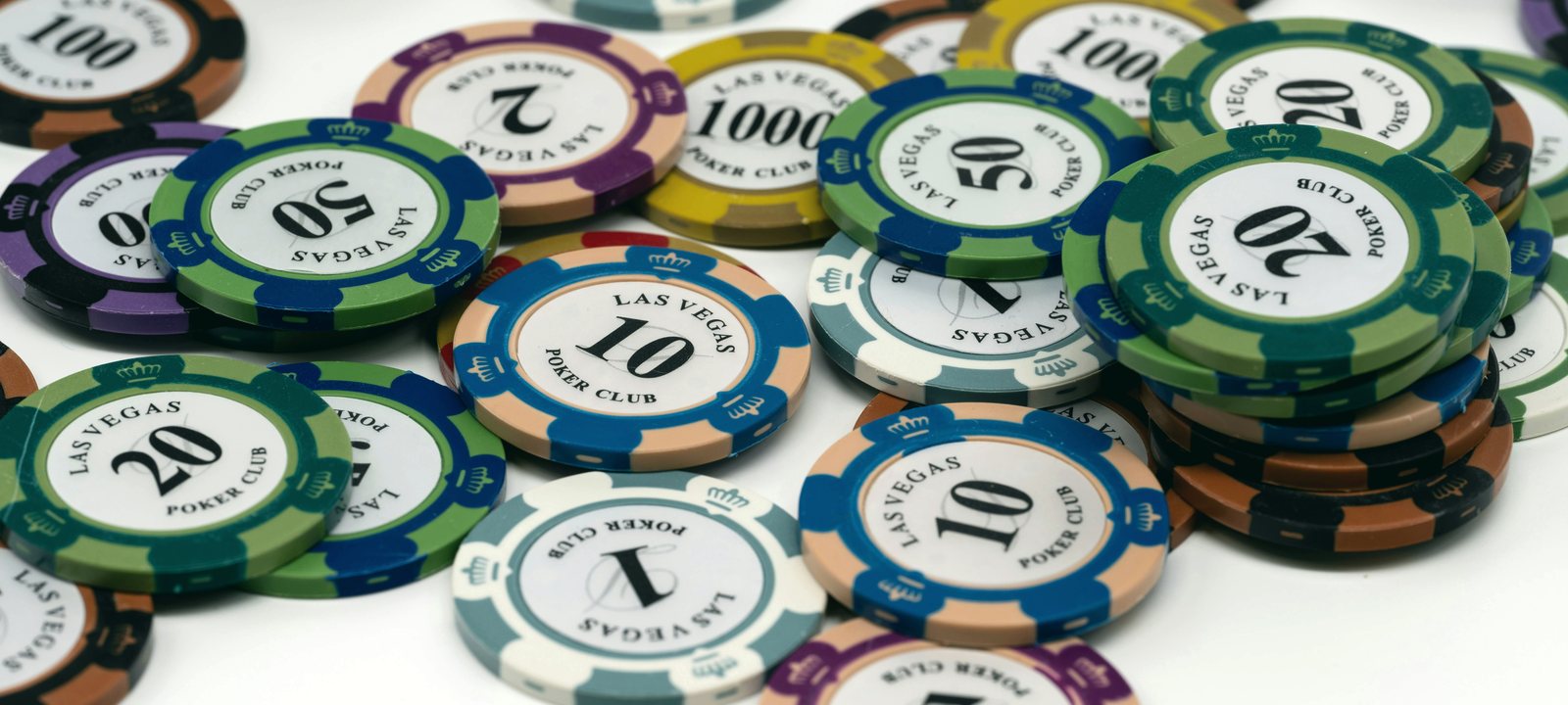 Poker chips on a light table, teal-graded